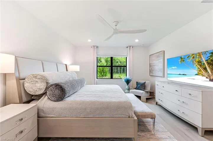Bedroom featuring ceiling fan and light hardwood / wood-style floors