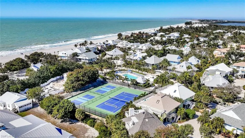 Aerial perspective of suburban area with expansive coastline