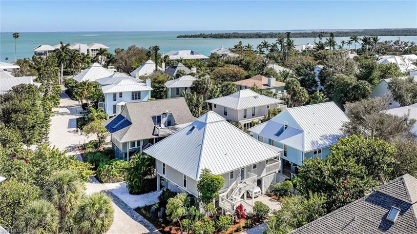 Aerial view of residential area featuring a nearby body of water