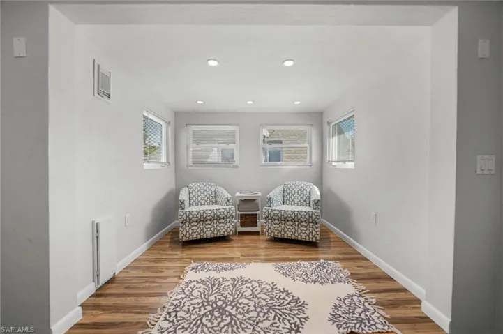 2nd Floor Primary Bedroom sitting area w/ light wood-type flooring, healthy amount of natural light, and recessed lighting