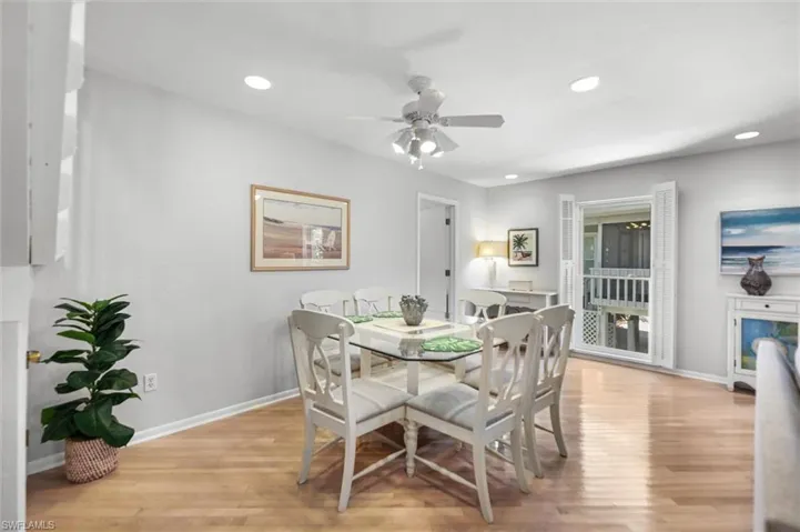 Dining area featuring light wood-style flooring, a ceiling fan, and recessed lighting