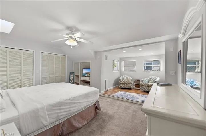2nd Floor Primary Bedroom with two closets, ceiling fan, a skylight, and vaulted ceiling