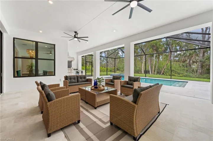 View of patio / terrace featuring a lanai, outdoor lounge area, and ceiling fans