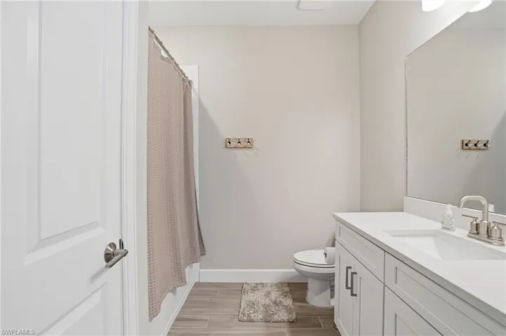 Bathroom featuring wood finish floors and vanity