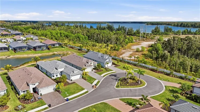 Aerial perspective of suburban area featuring a large body of water