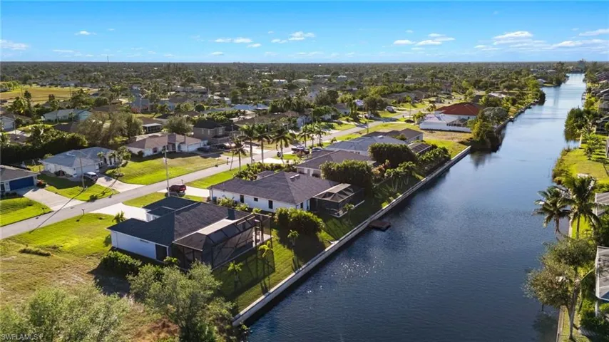 Birds eye view of property with a water view