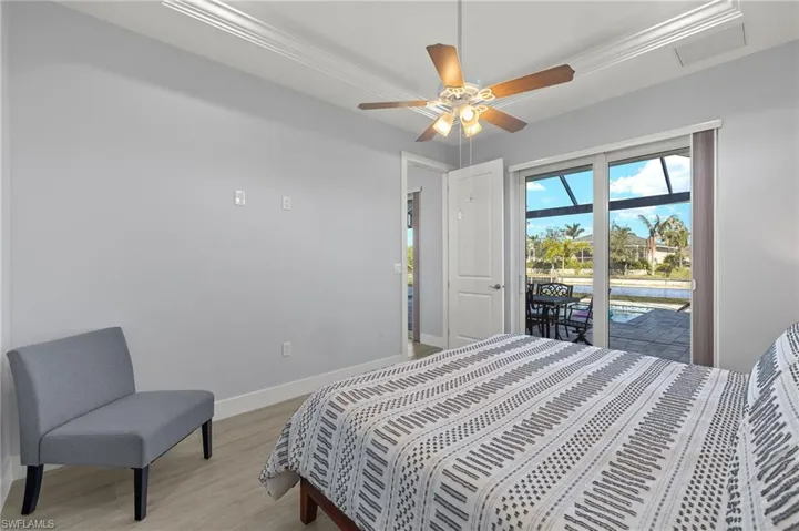 Bedroom featuring access to exterior, ceiling fan, crown molding, and light wood-type flooring