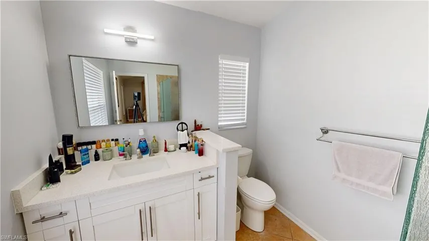 Master Bathroom featuring vanity, toilet, a healthy amount of sunlight, and walk in shower