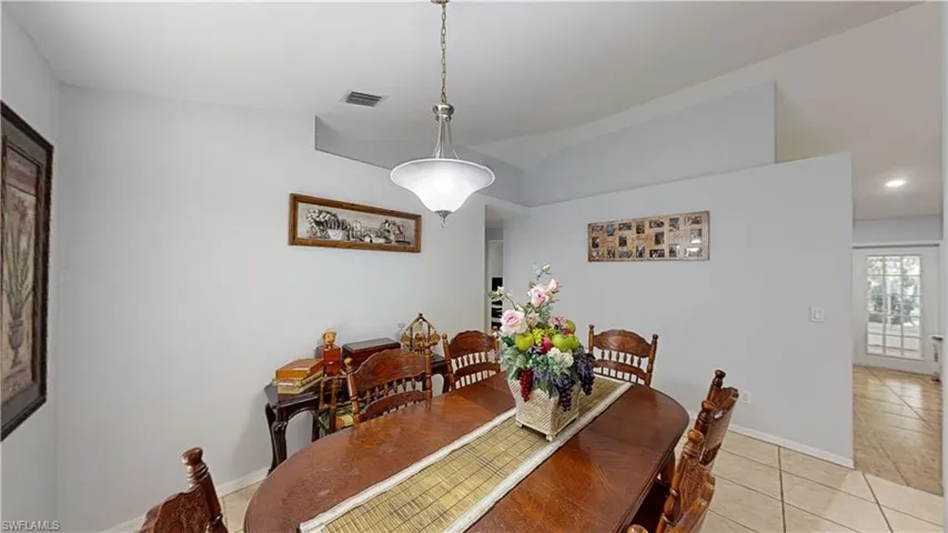 Tiled dining area with vaulted ceiling