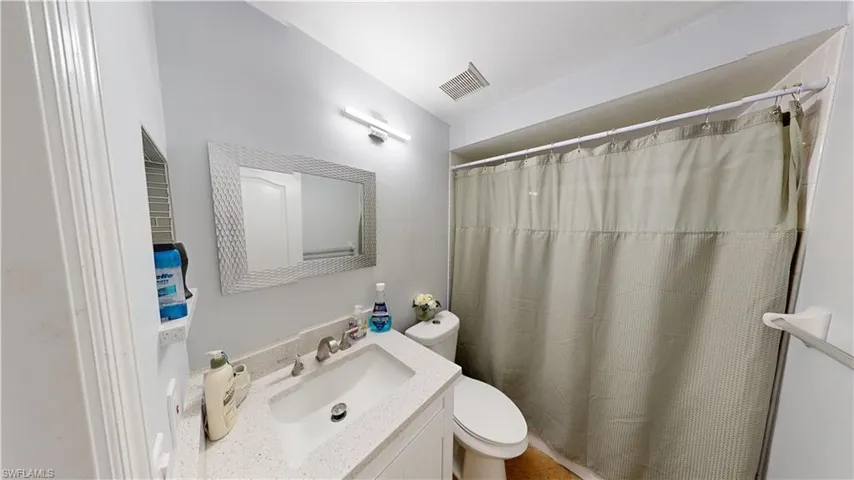 Bathroom featuring vanity, toilet, and tub shower combo