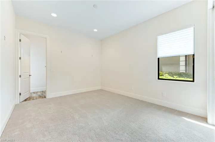Spare room featuring light carpet and recessed lighting