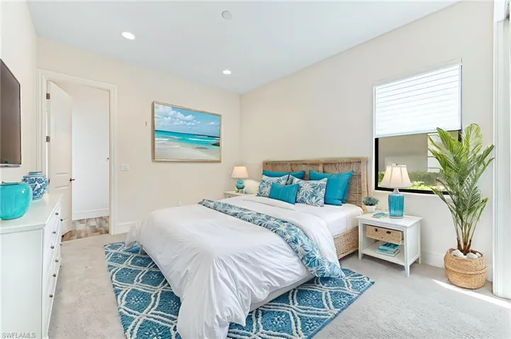Carpeted bedroom with recessed lighting and baseboards