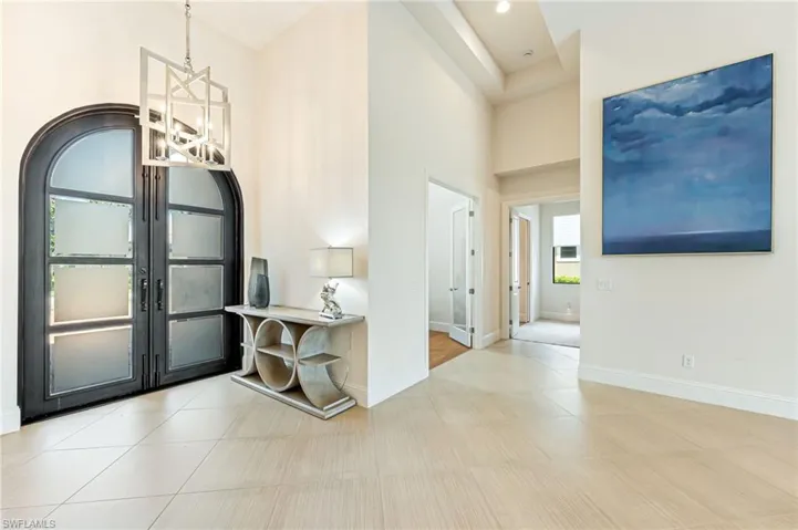 Foyer entrance featuring a high ceiling and light tile patterned floors