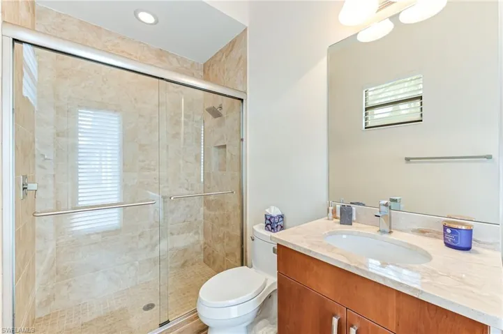 Full bath with vanity, a shower stall, and recessed lighting