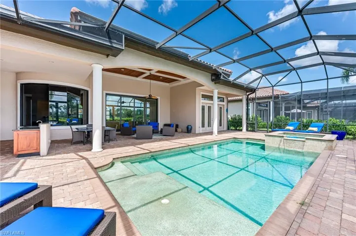 View of swimming pool featuring a patio area, a sunroom, and a lanai