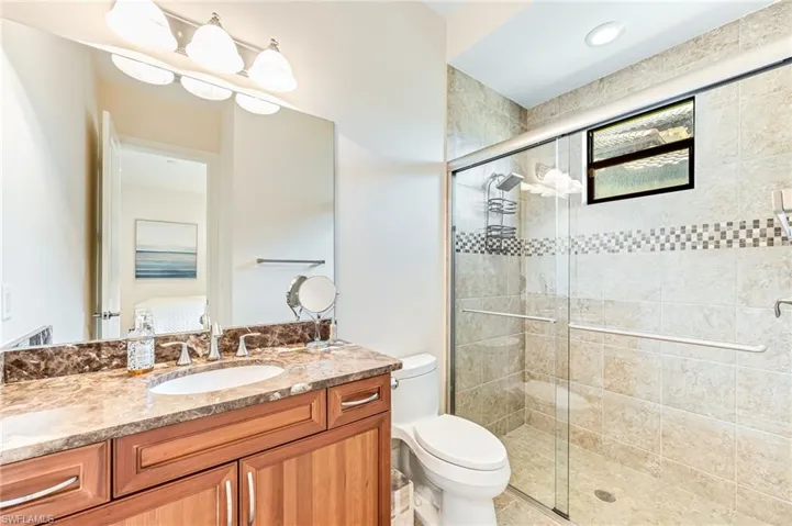 Full bathroom featuring a stall shower and vanity