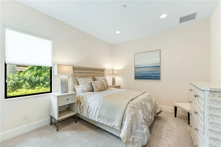 Bedroom with light carpet and recessed lighting