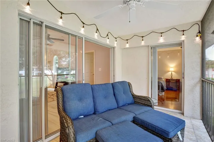 Screened lanai with view of Pools and landscaped area