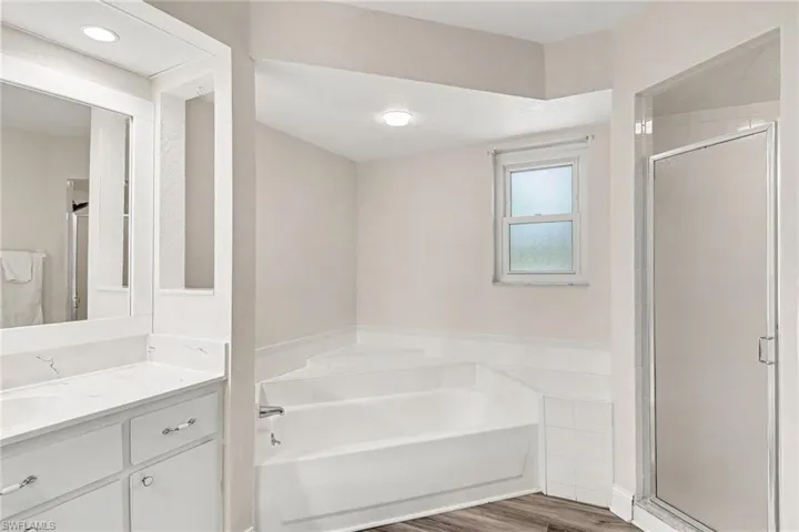 Primary Bathroom with soaking tub and stand up shower. Plus linen closet.