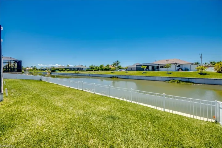 Water view featuring a fenced backyard and nearby suburban area