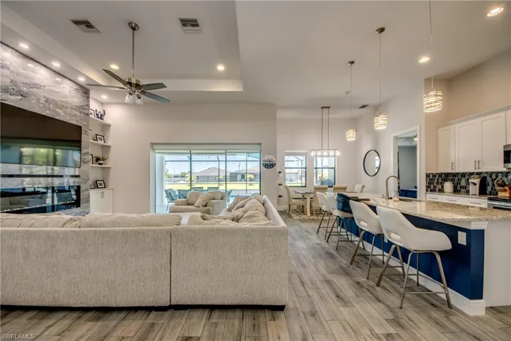 Living area featuring light wood finished floors, recessed lighting, and a ceiling fan