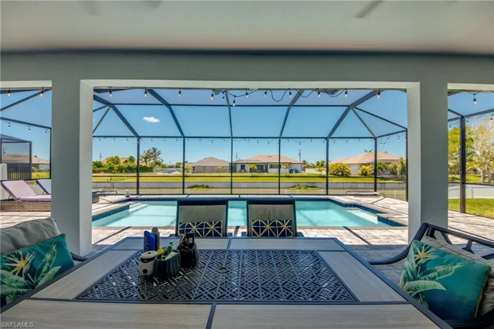 Outdoor pool featuring a patio and glass enclosure
