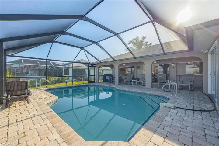 View of pool featuring a patio area and a lanai