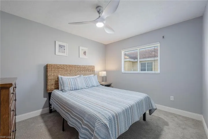 Carpeted bedroom with ceiling fan
