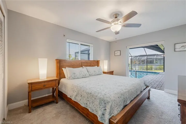 Bedroom with access to exterior, ceiling fan, carpet floors, and a closet