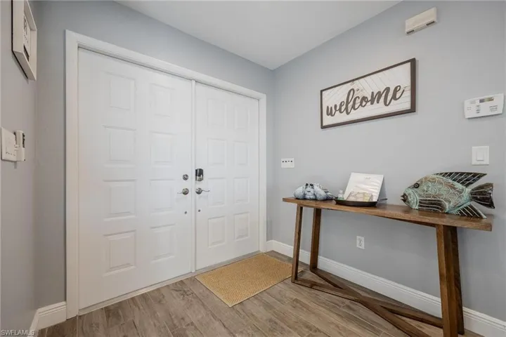 Foyer entrance with light wood-type flooring
