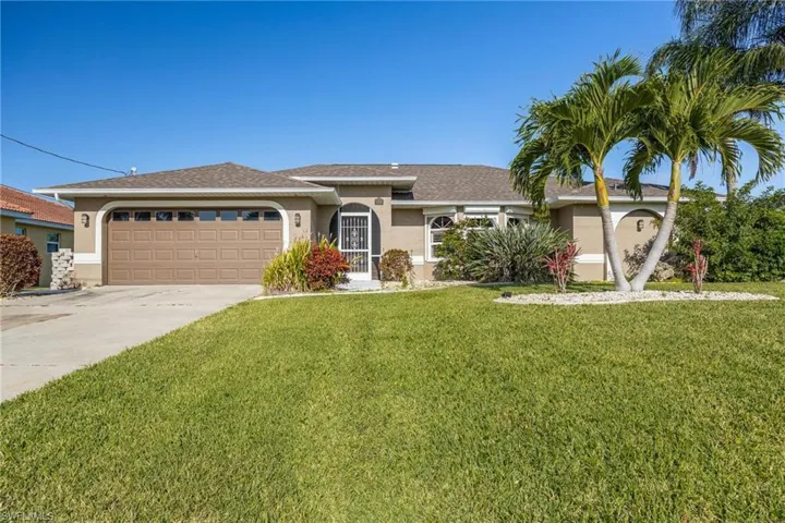 View of front facade with a front yard and a garage