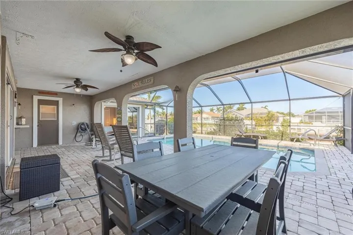 View of patio / terrace featuring ceiling fan and glass enclosure