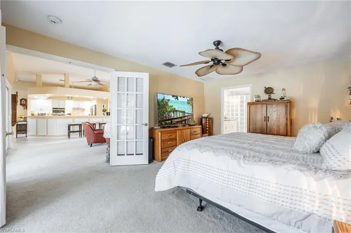 Bedroom with visible vents and light colored carpet