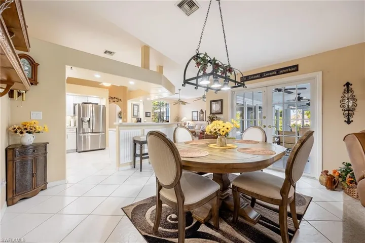 Dining room featuring light tile patterned floors, visible vents, a wealth of natural light, and french doors