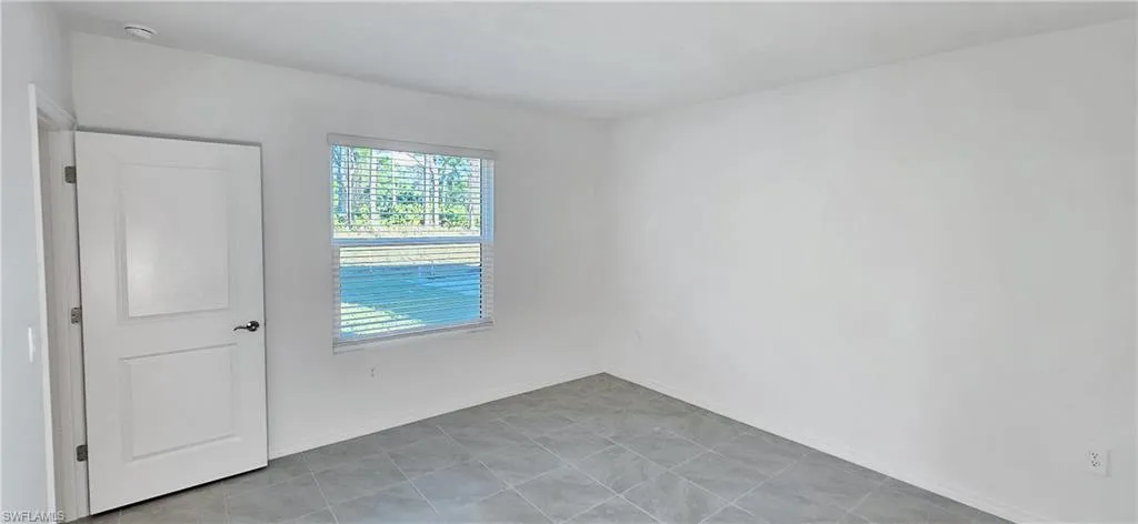 Unfurnished room featuring baseboards