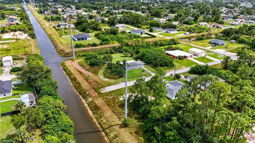Aerial perspective of suburban area featuring a large body of water