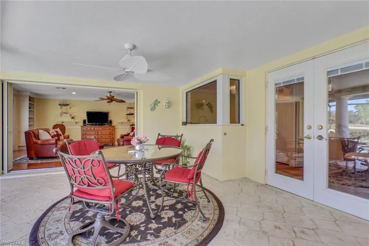 Dining space with a ceiling fan and french doors