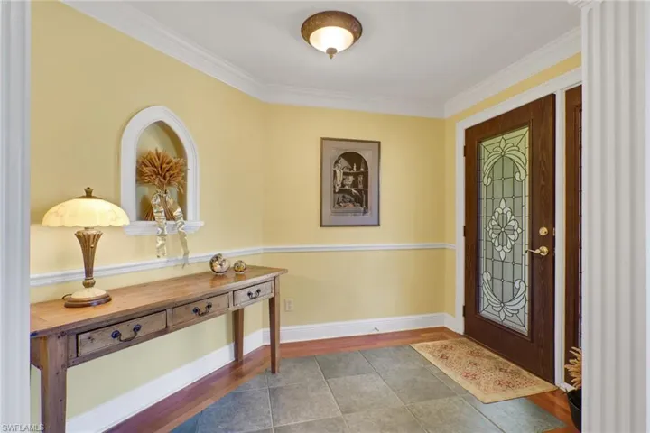 Tiled entryway with crown molding