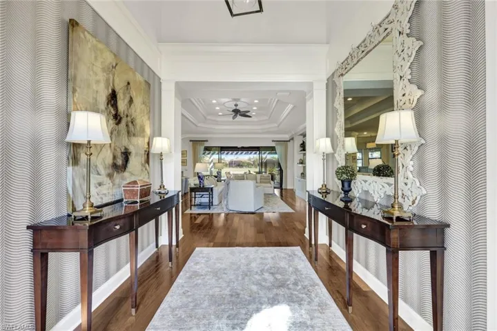 2 story entry featuring designer furnishings, extensive moldings and trim