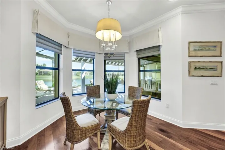 Breakfast area with custom window treatments and water view