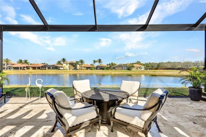 Lanai with premium water view, panoramic screened enclosure, pergola, built-in hot tub, outdoor kitchen, bar and covered living area