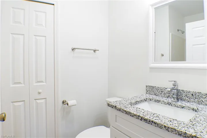 Full bathroom with a closet and vanity