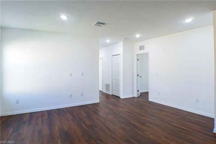 Unfurnished room with dark wood finished floors and recessed lighting