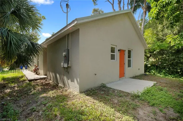 View of home's exterior with stucco siding and a patio