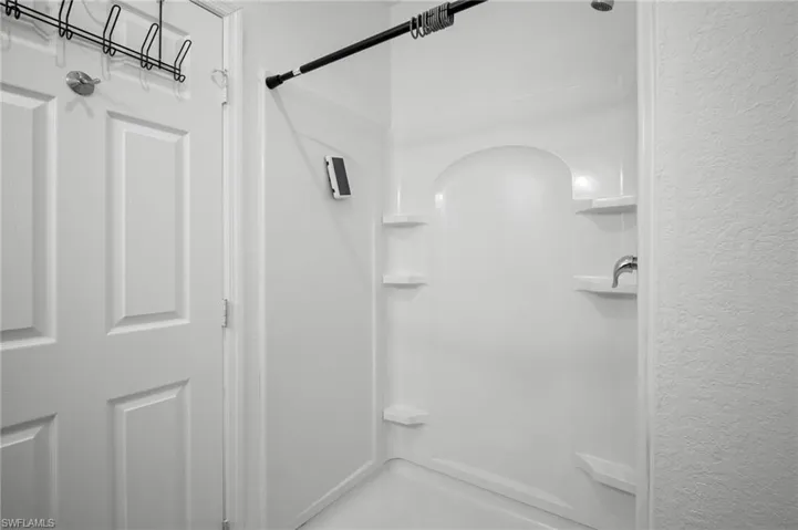 Full bathroom featuring a shower stall