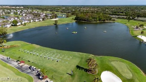 Aerial view of property's location with a local golf course and nearby suburban area