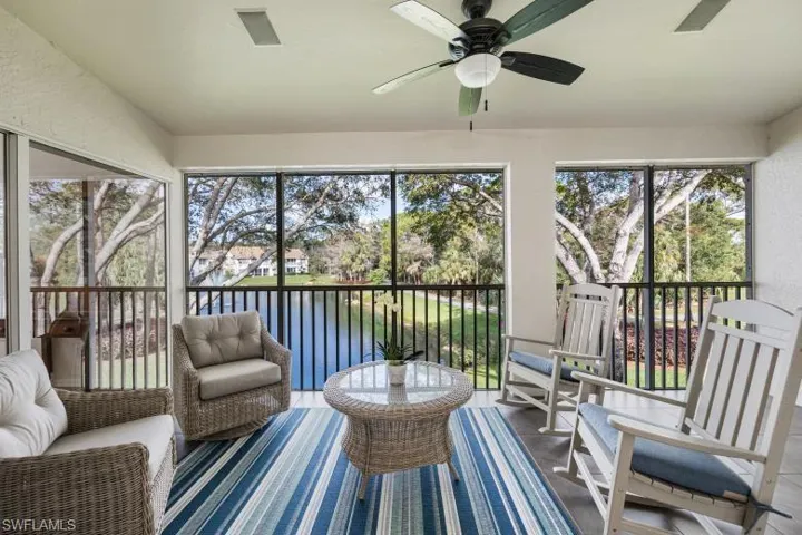 Sunroom with a water view and ceiling fan