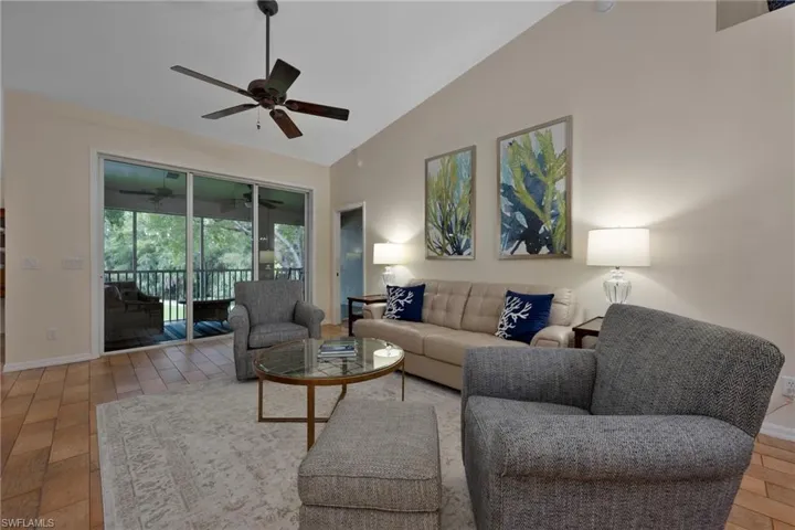 Living room featuring baseboards and high vaulted ceiling