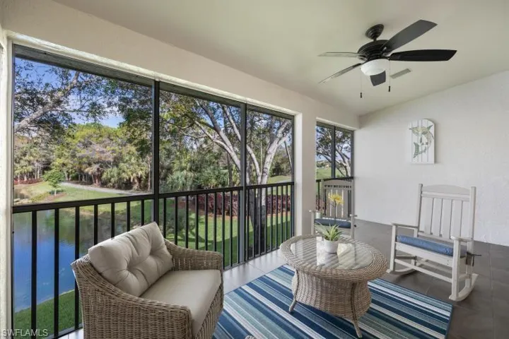 Sunroom featuring ceiling fan, a water view, and outdoor lounge area