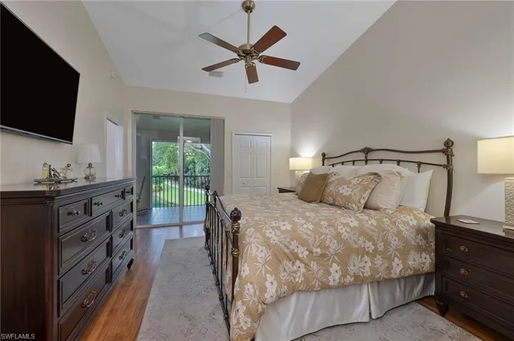 Bedroom featuring light wood-style floors, a closet, ceiling fan, access to outside, and high vaulted ceiling